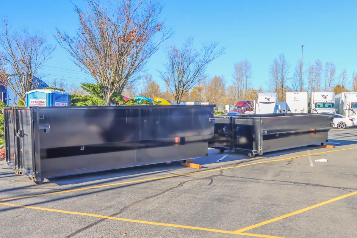 Professional dumpster rental service with roll-off container on residential driveway in Clearwater